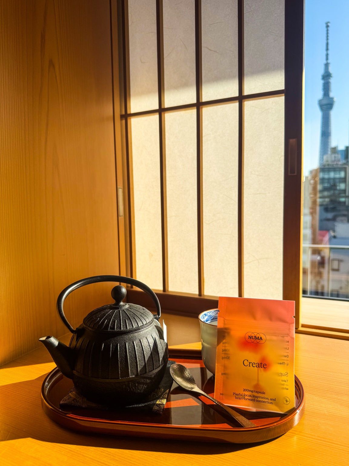 NUMA Create capsules beside a cast iron teapot in warm sunlight